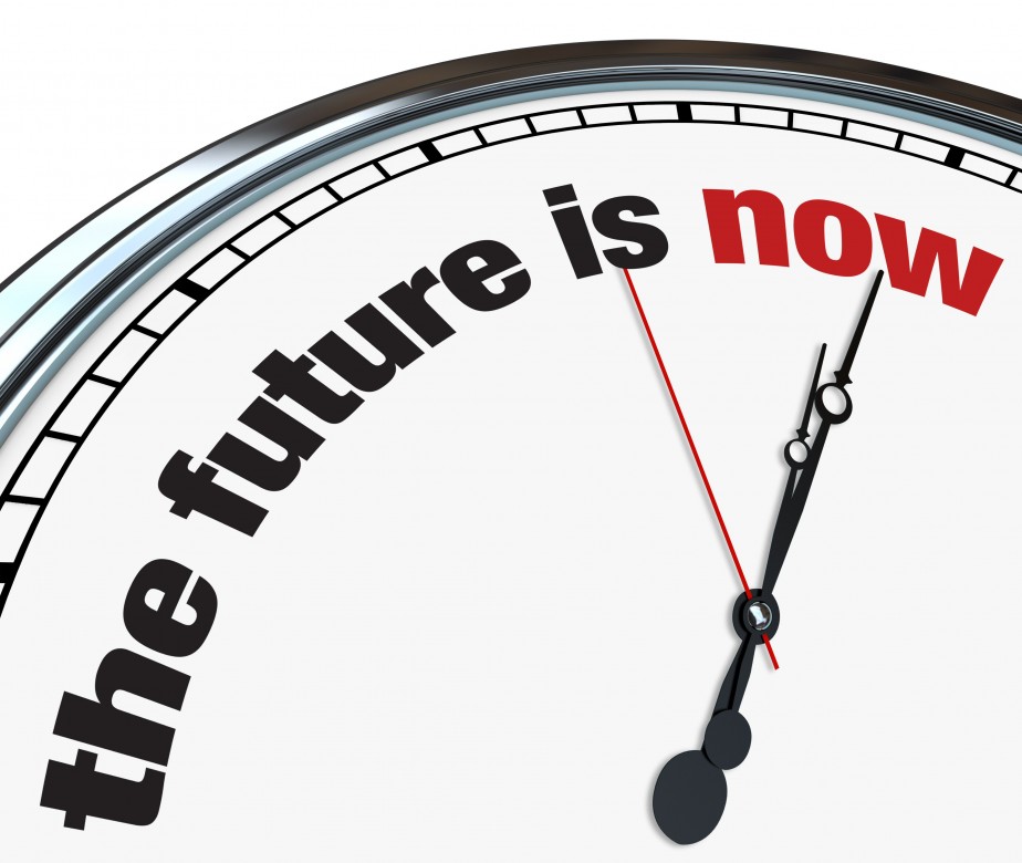 An ornate clock with the words The Future is Now on its face