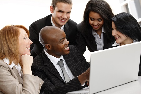 multiracial business team looking at a laptop